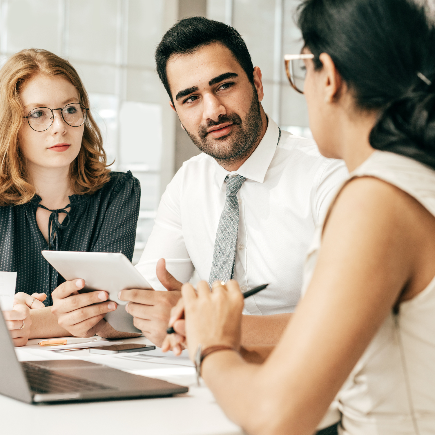 man and women listening to a women talk with computer